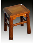 Brown Chinese Elm antique square stool with thick legs and flat top, shown against a gradient background.