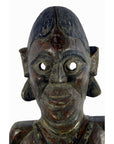 Brown wooden Sumatra fertility mask with large eyes, prominent ears, and carved details on a white background.