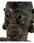 Close-up of weathered wooden Sumatra fertility mask with hollow eyes and large ears, 25 inches tall.