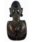 Brown wooden Sumatra fertility mask bust of a stylized female with necklace, hollow eyes, and pronounced facial features.