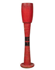 Red wood ceremonial drum with round base, ridged sides, and black central band shown freestanding.
