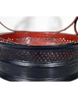 Close-up of red and black woven Antique Thailand basket with circular handles and open lattice design.