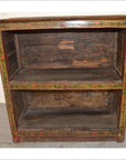 Brown wood antique Tibetan bookshelf with open shelves, hand-painted faded floral edges, and visible rustic wear.