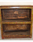 Brown rustic wood Tibetan bookshelf with two shelves and hand-painted vintage details, visible aged wear.