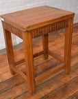 Brown wood Art Deco stool with carved details on wooden floor, vintage Shanghai style.
