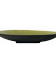 Green ceramic artisan bowl with dark exterior, side view, from the Prem Collection.