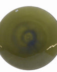 Close-up of an olive-green ceramic bowl with a subtle blue center and small white sticker on the rim.