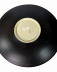 Black ceramic bowl bottom view with artisan finish, large size, white sticker at center of base.