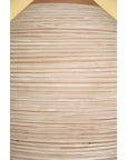 Close-up of light brown ceramic vase with evenly spaced horizontal white lines.
