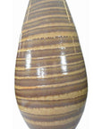 Close-up of large ceramic vase in glossy earth tones with brown and tan horizontal stripes, wood grain look.