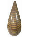 Close-up of large white ceramic vase with glossy brown and tan teardrop stripes.