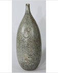 Close-up of large ceramic vase with narrow neck, mottled gray textured surface, set against a plain background.