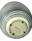 Close-up bottom view of a blue-striped ceramic vase with "MADE IN THAILAND" on the base.