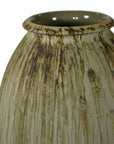 Close-up of beige and brown ceramic vase with streaked glaze and wide, round opening.