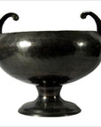 Silver hammered metal Asian bowl with two upward-curving handles on a short pedestal base, close-up view.