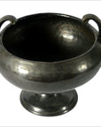 Silver hammered metal Asian bowl with two side handles and round pedestal base, close-up on white background.