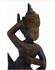 Brown wood Balinese hand carved temple dancer with one arm raised, eyes closed, on a white background.