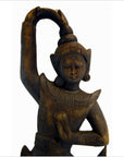 Brown wood Balinese hand carved temple dancer figurine on a 27 inch shelf wall decor setting.