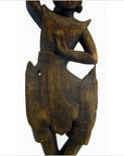 Brown wood Balinese hand carved temple dancer, close-up, displayed for wall decor or on a 27 inch shelf.
