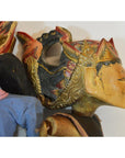 Close-up of a colorful wooden Balinese puppet with painted face and ornate hand-carved headdress.