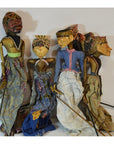 Colorful wooden Balinese puppets with hand-carved faces, close-up group view.