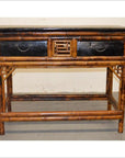 Black lacquered bamboo desk with two black drawers and wood accent, modern style, front view.