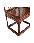 Close-up of dark bamboo horseshoe chair with woven detailing and glossy seat, 19th century style.