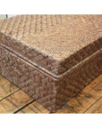 Rectangular bamboo trunk with lid on a wooden floor, natural finish, home storage furniture.