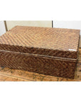 Large bamboo trunk on wooden floor against plain wall, natural finish, product displayed in simple indoor setting.