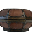 Close-up of octagonal antique wood basket with lid, dark edges, gold details, and textured reddish-brown panels.
