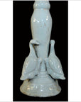 White porcelain candle holder with two duck figurines on a white base, black background, close-up view.