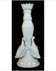 White porcelain candle holder with duck figures, Blanc de Chine style, close-up on a black background.