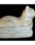 White porcelain cat figurine, glossy finish, reclining in profile against a black background, side view.