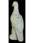 White porcelain dove with textured wings on a bold black background.