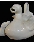 White porcelain duck-shaped teapot with open beak design, close-up view.