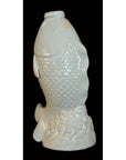 White porcelain fish with detailed scales, rising from stylized waves, displayed on a black background.