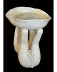 White porcelain monkey with three sculpted legs, Blanc de Chine, close-up against a black background.