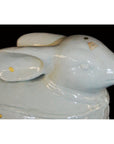 White porcelain rabbit figurine with glossy finish and price tag, shown against a black background.