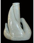 Pale porcelain vase with crackled glaze, rounded form, Blanc de Chine style, on black background.