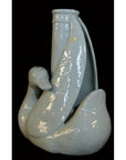 White porcelain swan vase with curved neck, Blanc de Chine style, close-up against a black background.