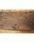 Dark wood Indonesian blanket chest with a weathered finish, placed on a wooden floor.