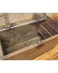 Brown wooden blanket chest with floral-patterned bone inlay front, open lid, small internal compartment visible.