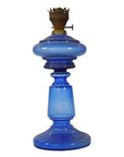 Close-up of antique blue glass oil lamp with brass burner and round base, very good condition.