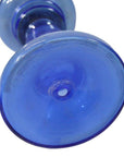 Close-up of antique blue glass oil lamp base, showing circular patterns and intact condition from an underside view.