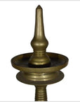 Close-up of an antique-style brass incense burner with a pointed top, set against a plain white background.