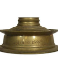 Close-up of brass incense burner with spiral design and engraved Malayalam script, antique-inspired style.