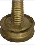 Close-up of brass incense burner base with engraved patterns and spiral design.