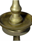 Close-up of brass incense burner with spiral design and round base on white background.
