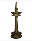 Close-up of a brass incense burner with spiral design and pointed top, inspired by antique Indian ceremonial lamps.