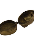 Close-up of a round brass box with a hinged lid and antique detailing, Brass Monkey Head Box.